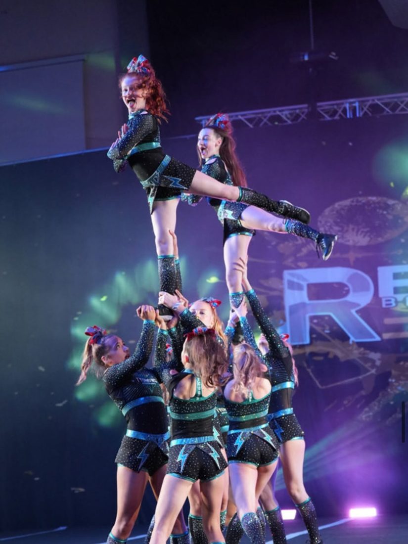 Tycoons cheer team performing a stunt on stage