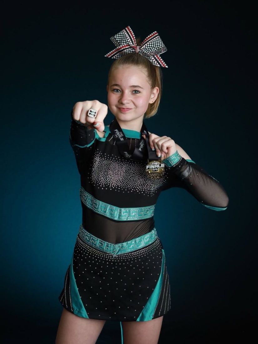 Tycoons athlete showing her Nfinity Finals champion medal and ring